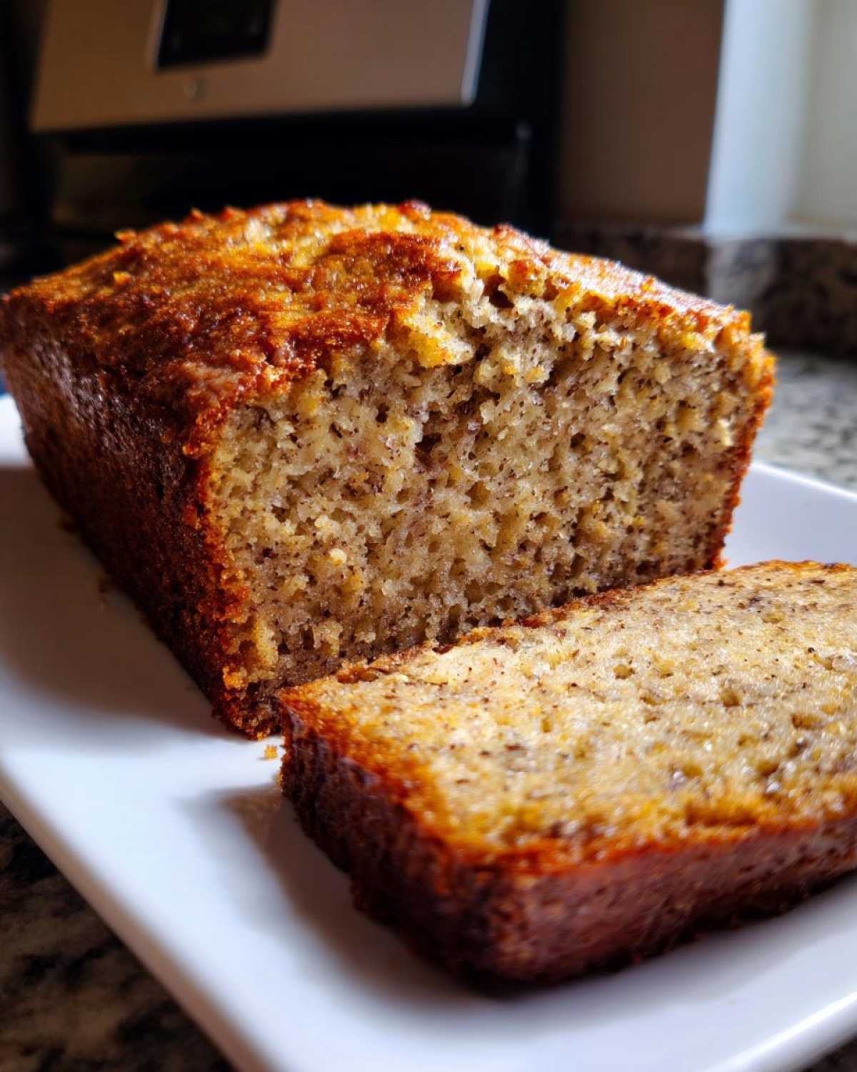 Close-up of a moist loaf of the best banana bread, sliced to show the texture.
