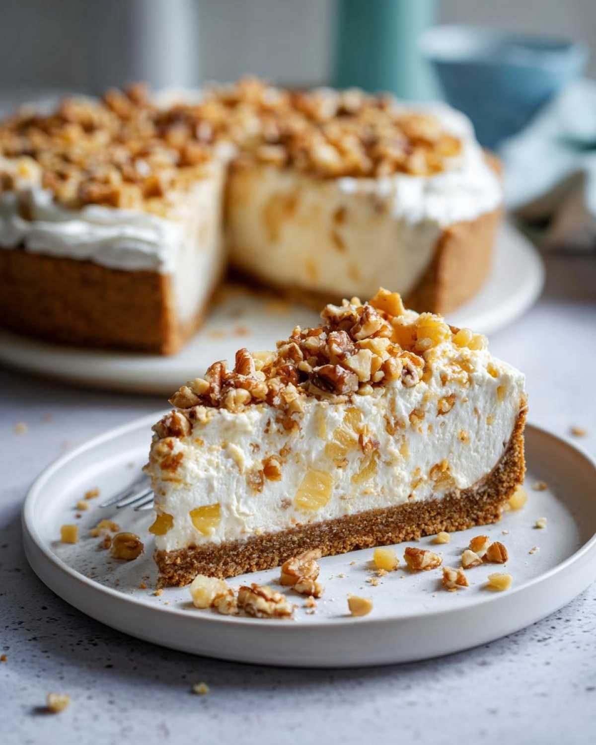 A close-up slice of creamy Million Dollar Pie with pineapple chunks, topped generously with chopped nuts.