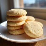 A stack of five incredibly soft sugar cookies coated in cinnamon sugar, resting on a white plate.