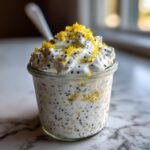 Close-up of an Easy Lemon Poppy Seed Yogurt Parfait topped with bright yellow lemon zest.
