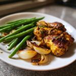 A serving of One-Pan Dijon Chicken with Green Beans and Shallots on a white plate.