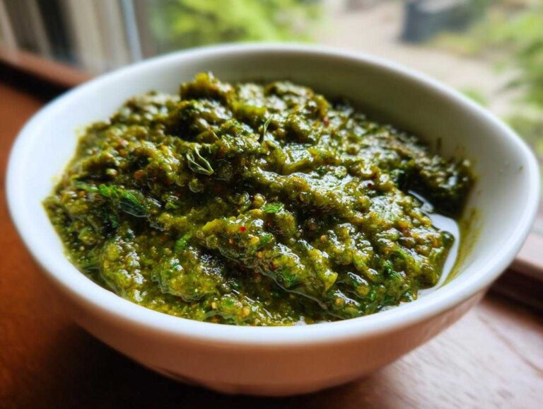 Close-up of a thick, vibrant green Authentic Salsa Verde Recipe served in a small white bowl.