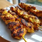 Close-up of several golden, charred chicken skewers, representing one of the 5 BOLD Lee Cronin's The Mummy skewers.