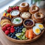 A beautiful, fully loaded Breakfast Grazing Board for Moms featuring bagels, smoked salmon, fruit, and dips.