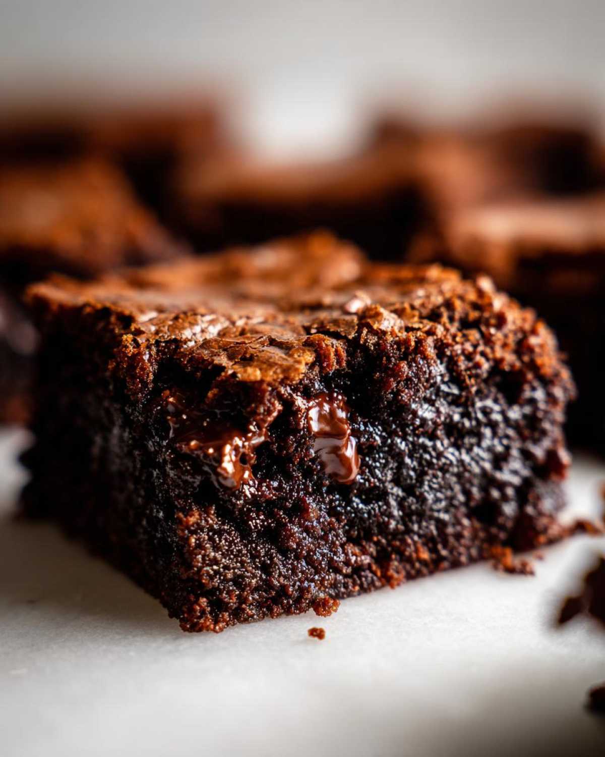 Close-up of a rich, fudgy square of chocolate cobbler showing melted chocolate chips.