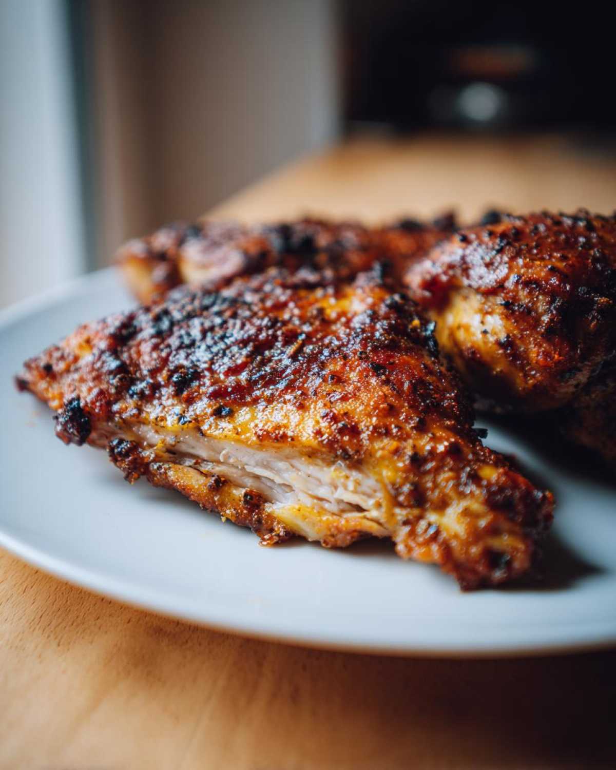 Close-up of perfectly cooked, seasoned chicken thighs showing the juicy white meat inside.