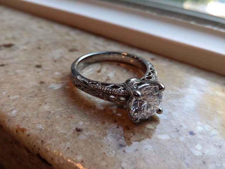 Close-up of a stunning solitaire engagement ring with intricate filigree detailing, part of the process to Create Your Dream Ring.