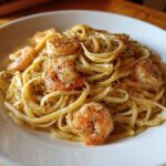 Close-up of delicious Garlic Butter Shrimp Pasta tossed in a creamy sauce and topped with seasoned shrimp.
