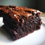 Close-up shot of a rich, dark, fudgy brownie slice showing a crackly top crust from the Easy Chewy Brownies Recipe.