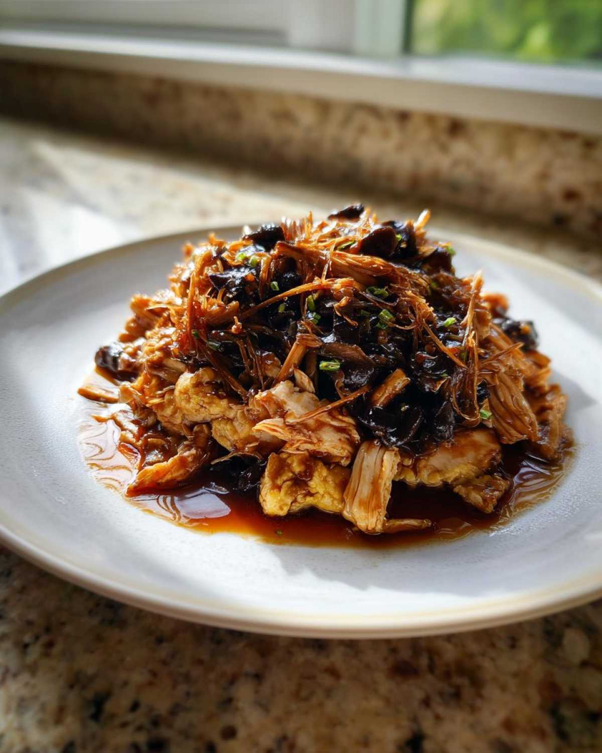 Close-up of Moo Shu Chicken Authentic Chinese Stir Fry Dinner with shredded chicken and dark mushrooms in savory sauce.