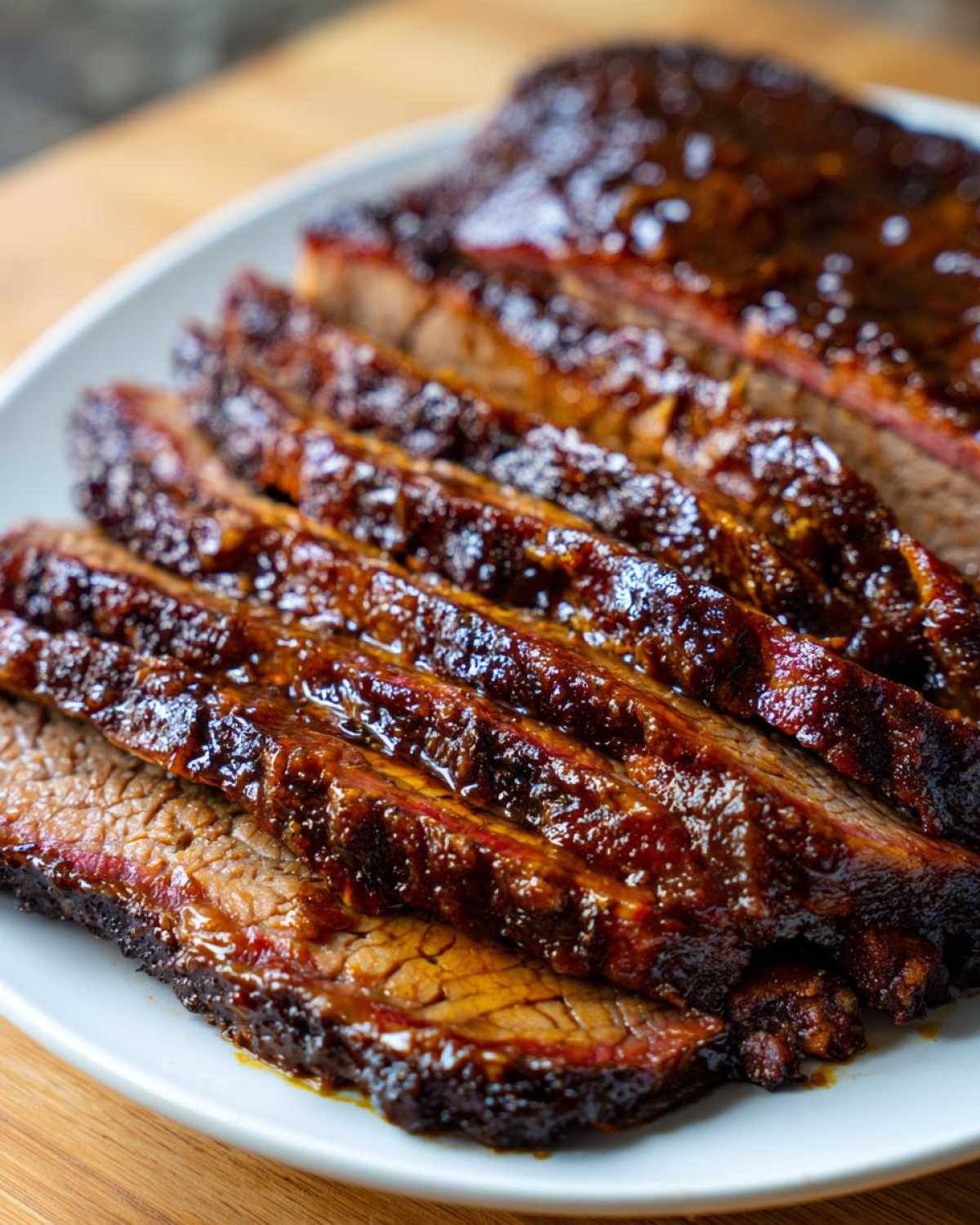 Close-up of tender, sliced Slow Cooker Brisket covered in a rich, glossy barbecue glaze.